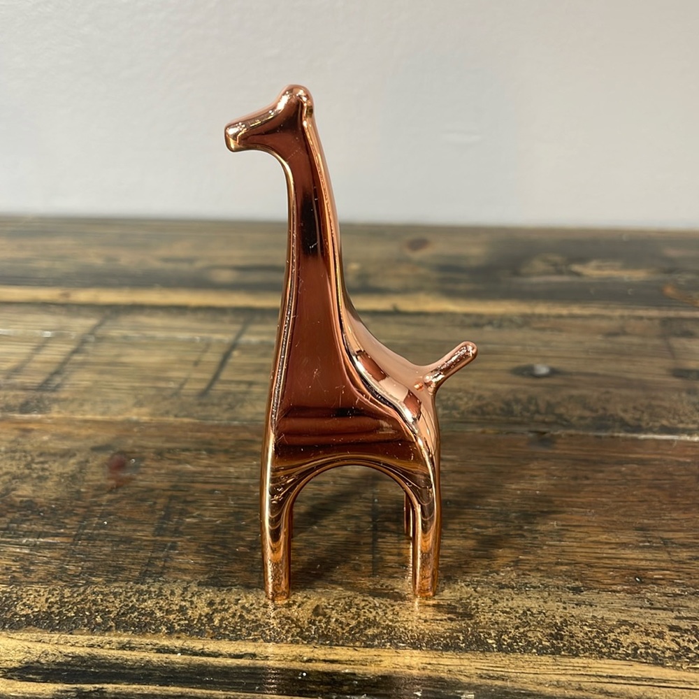 Umbra copper plated ring holder giraffe.  Rings not included.